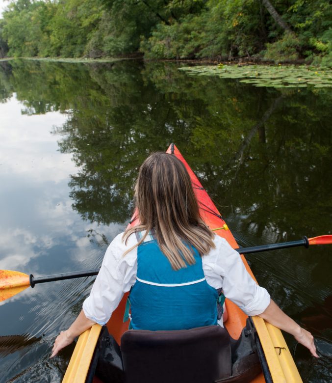 Girl in a kayak on a river